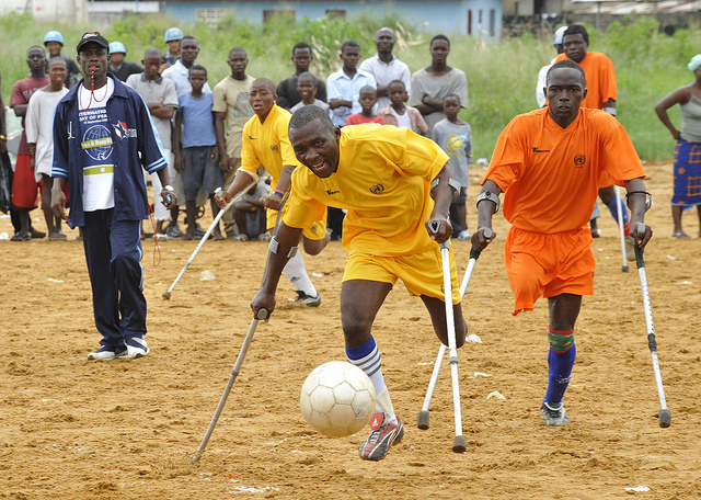 individuals on crutches playing soccer