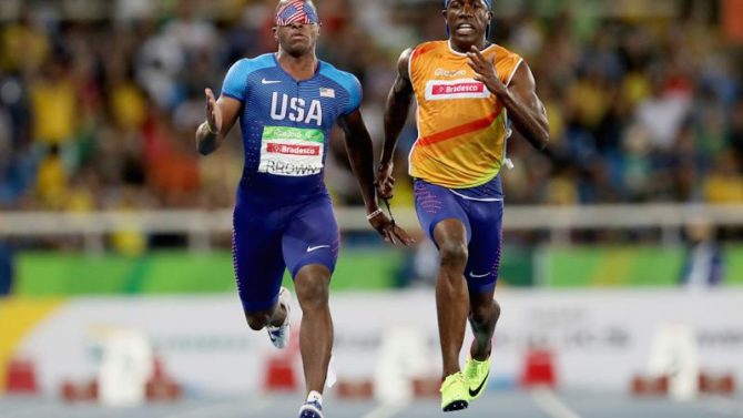 David Brown a Paralympian in track and field and his guide Jerome Avery. Image of the 2 men running in a race.