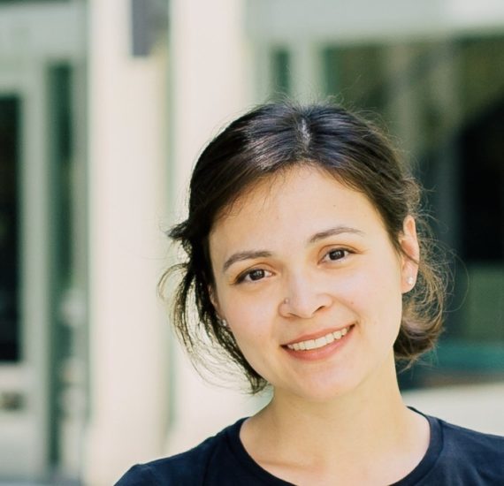 Image of romance author Helen Hoang. A 30 something woman in a blue shirt with her hair pulled back in a ponytail.