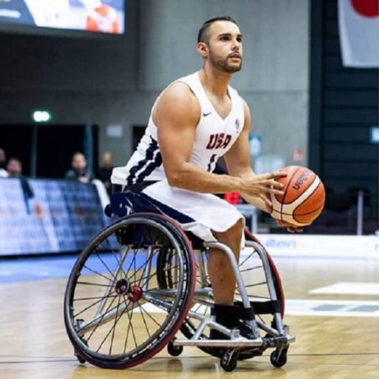 Jorge Sanchez a Paralympian in wheelchair basketball. Image of Jorge in his wheelchair getting ready to take a shot with the basketball.