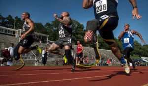 Staff Sgt. Rey Edenfield (far right), an Air Force wounded warrior athlete, sprints toward the finish line with fellow competitors at the 2015 Department Of Defense Warrior Games at the National Museum of the Marine Corps in Quantico, Va., June 23, 2015. The Warrior Games features athletes from throughout the Defense Department who compete in Paralympic-style events for their respective military branches.   (U.S. Air Force Photo/Staff Sgt. Vernon Young Jr.)